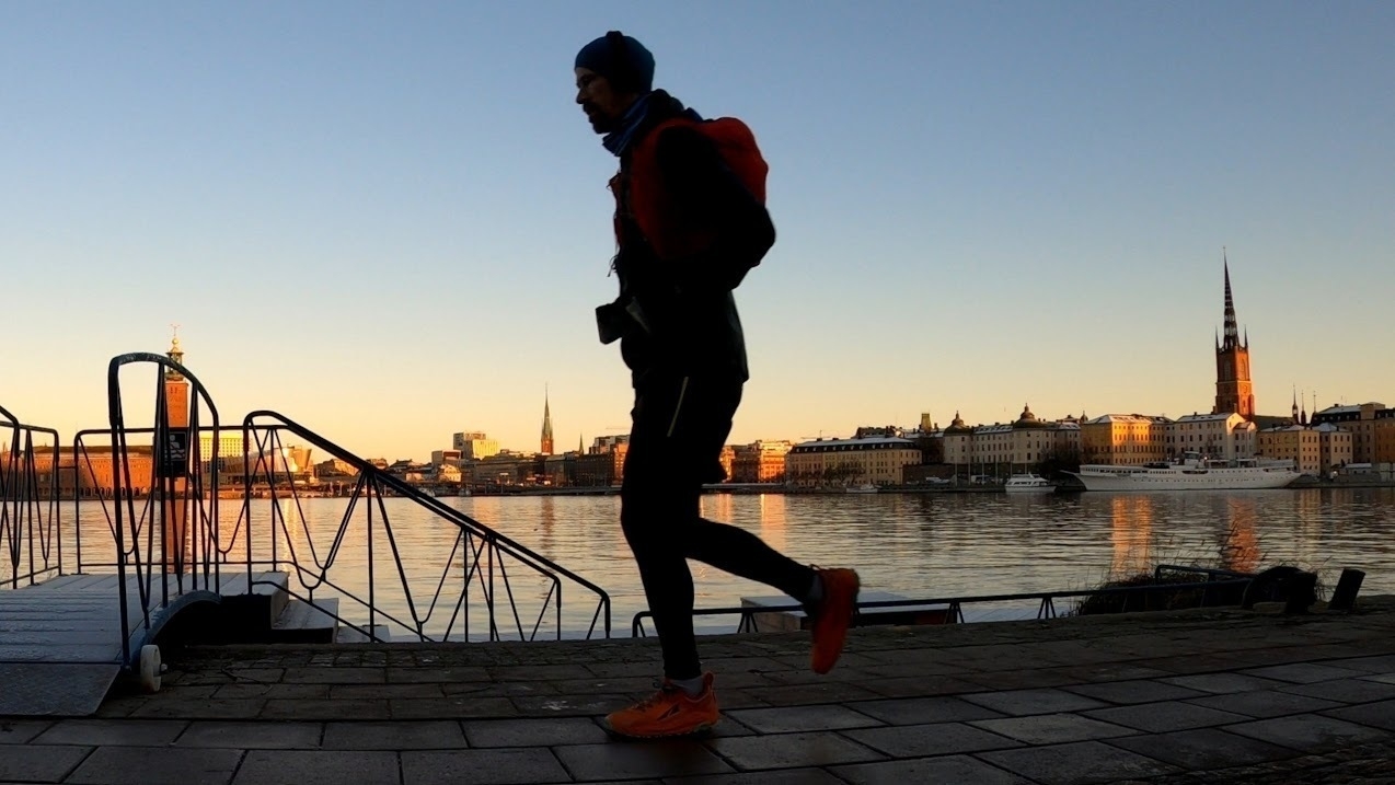 Me running with water and Stockholm City Hall in the background.