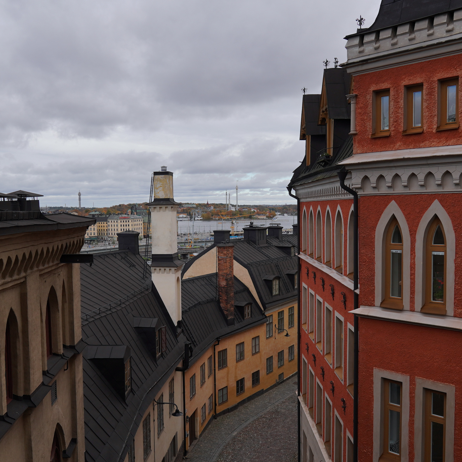 An alley viewed from a bridge where you can see a theme park in the far distance.
