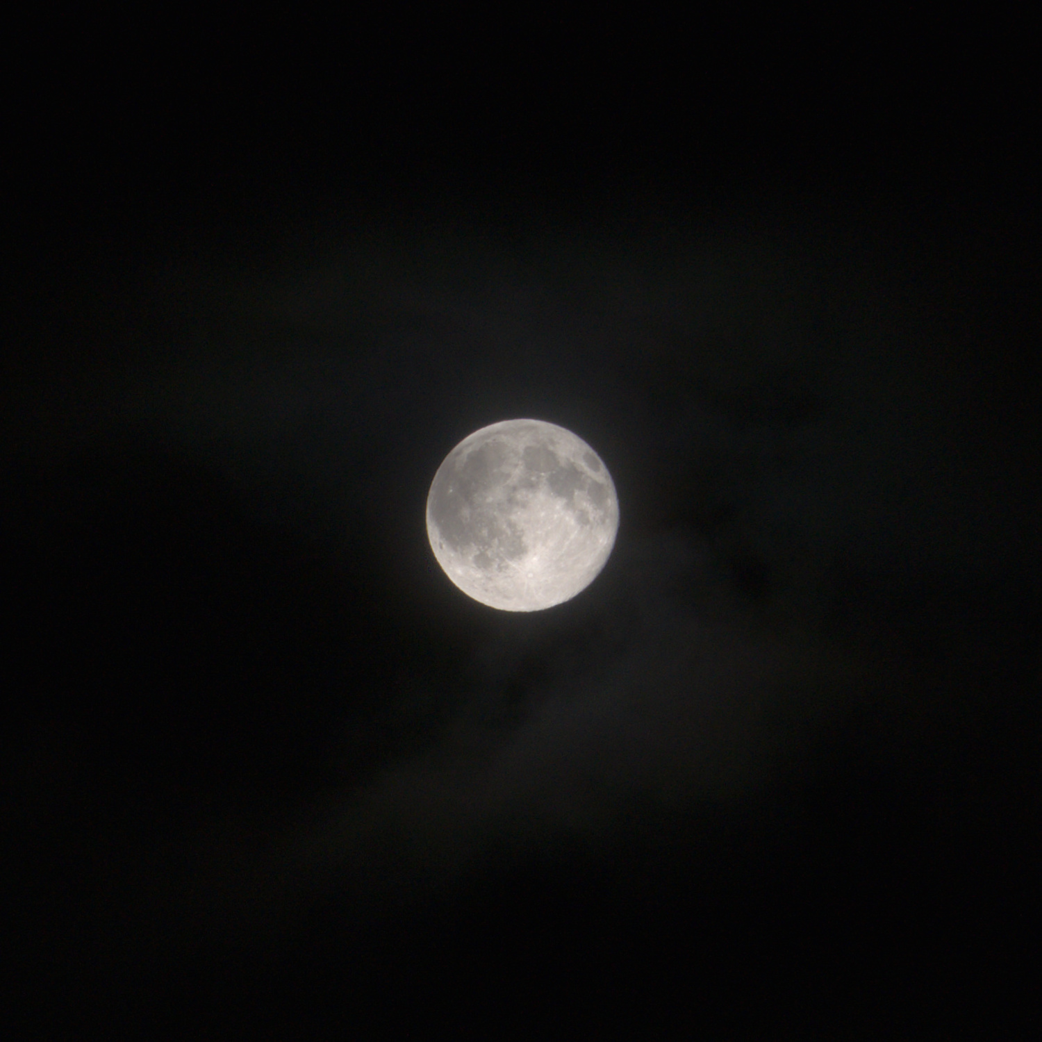 The moon with a black background and some clouds.